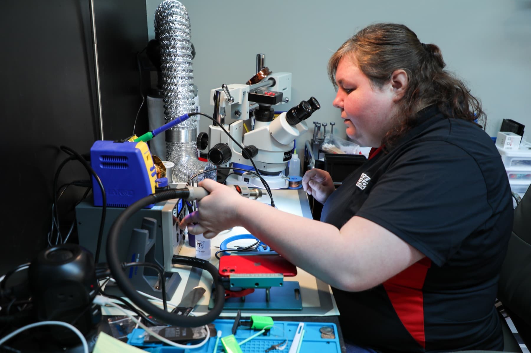 Geek2Go technician working at a microsoldering bench